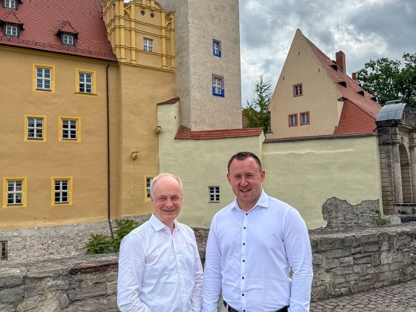 Die beiden Geschäftsführer der Stadtwerke Bernburg GmbH stehen vor dem Schloss Bernburg.